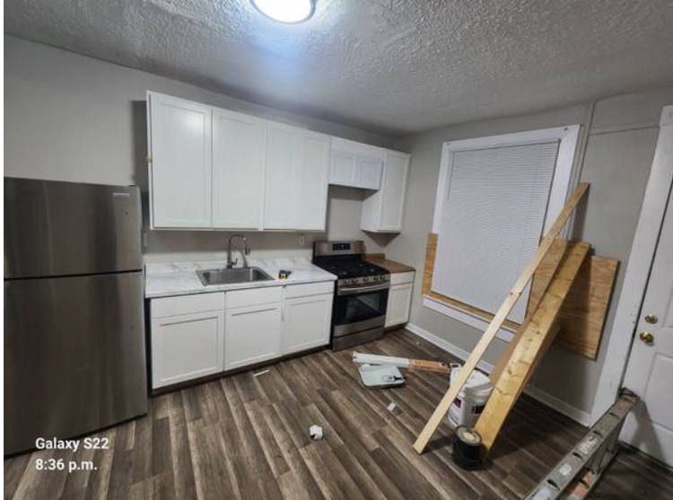 White kitchen cabinets with new countertop and range