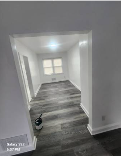 Freshly painted interior walls with new flooring and baseboards